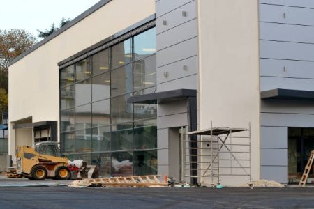 Varna, Bulgaria, November 2018. Facade of modern shopping center with a large window at the final stage of construction on a day